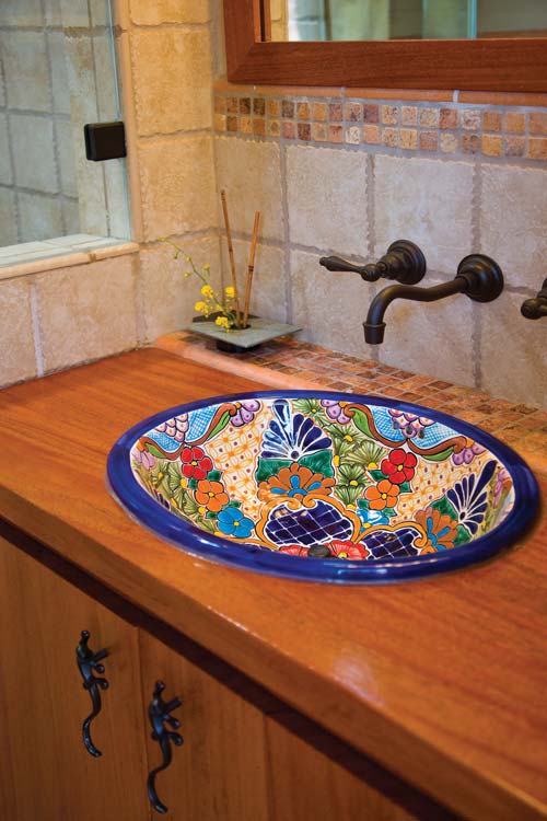 The homeowners purchased the unique Talavera sink during a trip to Pueblo, Mexico. Local artisans handcraft the vessels using local clay and then fire them using mineral-based enamels.
